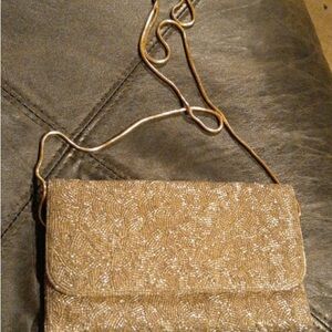 Gold sparkly soft feel purse.